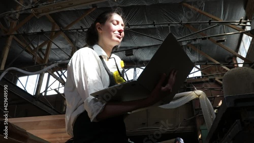 Wallpaper Mural Carpenter woman working  in her own woodshop using laptop Torontodigital.ca