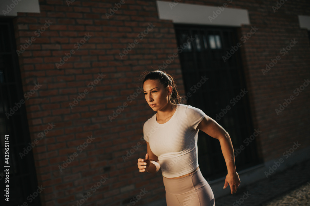 Young woman running on the street