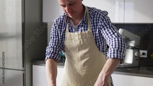 Man doing process mixing, making cake on a modern kitchen at home photo