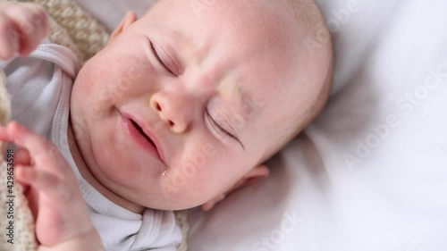 portrait of awake fussy baby infant starting to cry close-up view high angle
