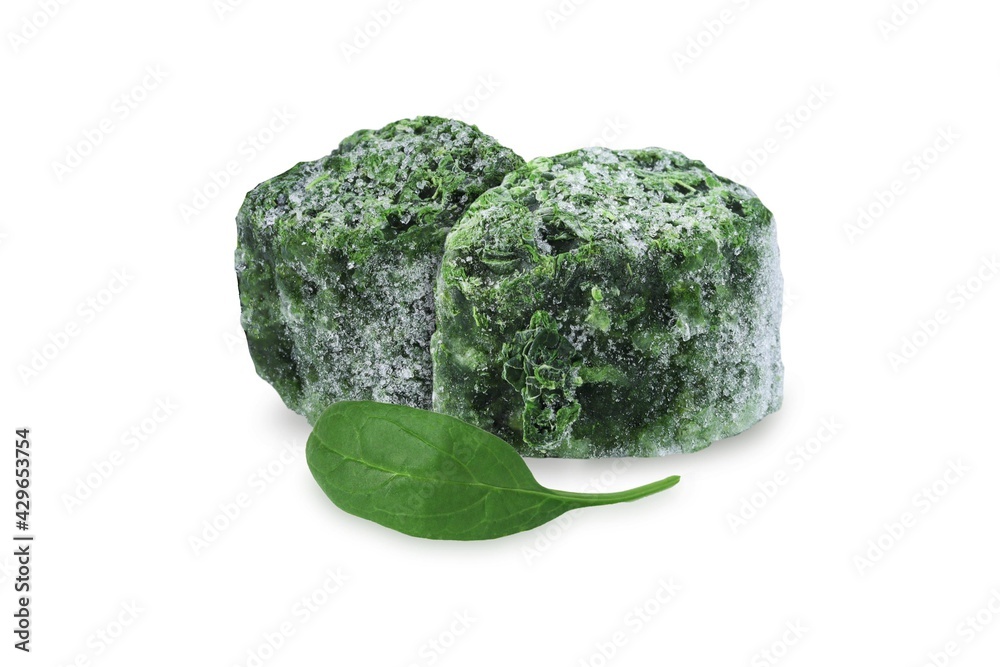 Fresh spinach leaf and frozen spinach cubes on an isolated white background. Fresh spinach leaf and frozen spinach cubes on an isolated white background.