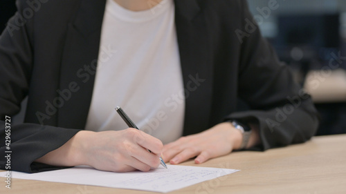 Close up of Female Hands Writing on Paper