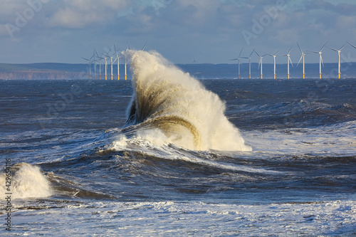 Canvas Print A Beautiful Wave with Wind Turbines in the distance