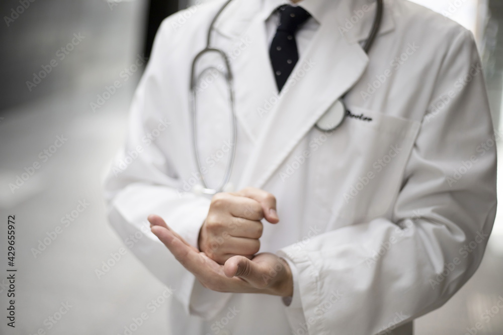 Doctor holding fist at hospital Doctor holding fist at hospital
