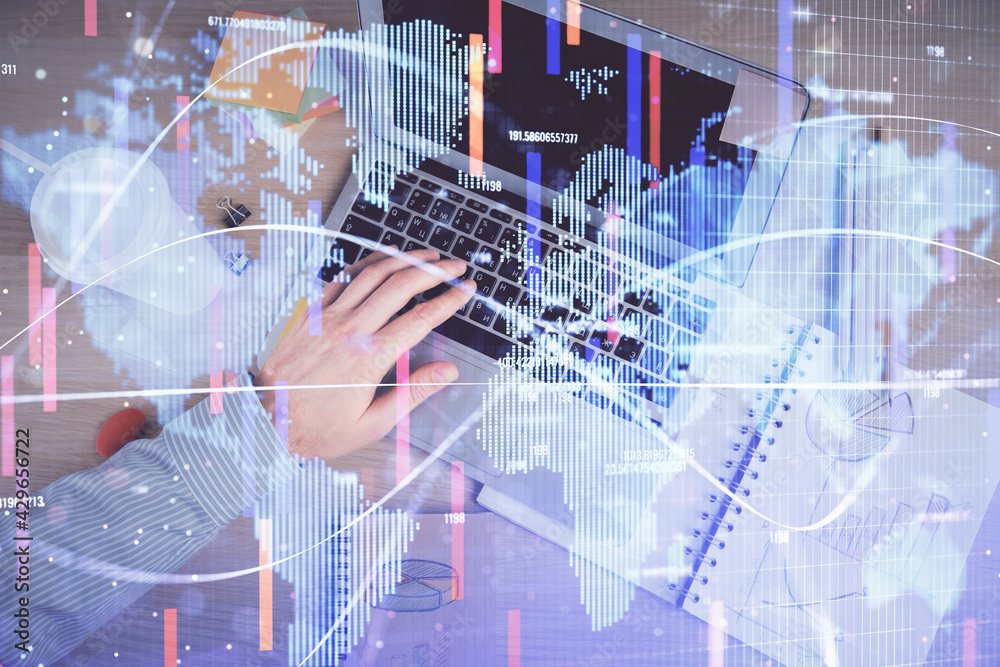 Double exposure of man's hands typing over computer keyboard and business theme hologram drawing. Top view. Financial markets concept. Double exposure of man's hands typing over computer keyboard and business theme hologram drawing. Top view. Financial markets concept.