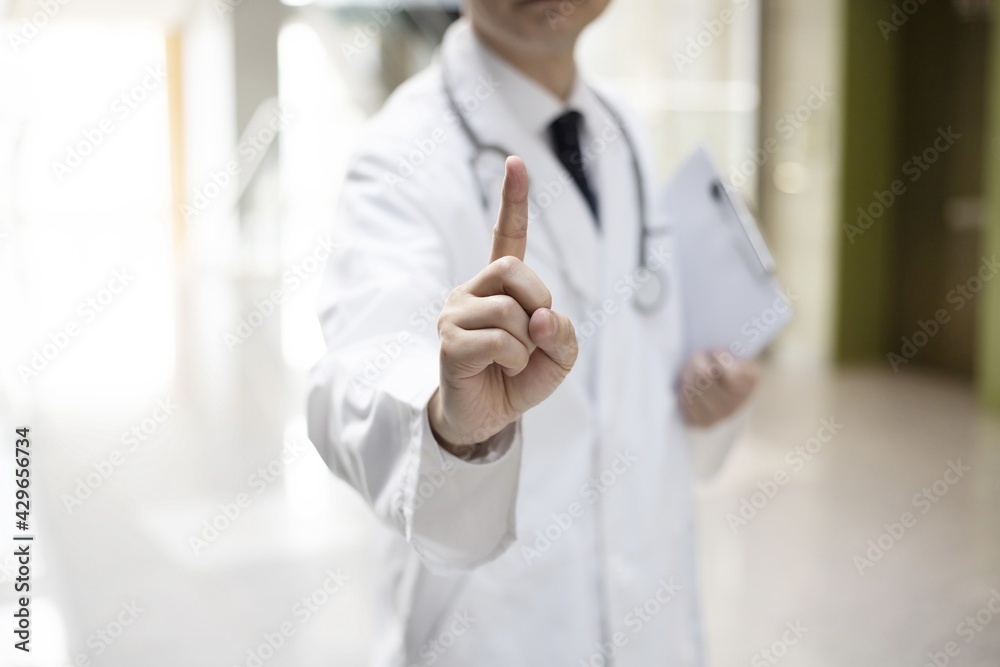Close up of doctor pointing up finger Close up of doctor pointing up finger