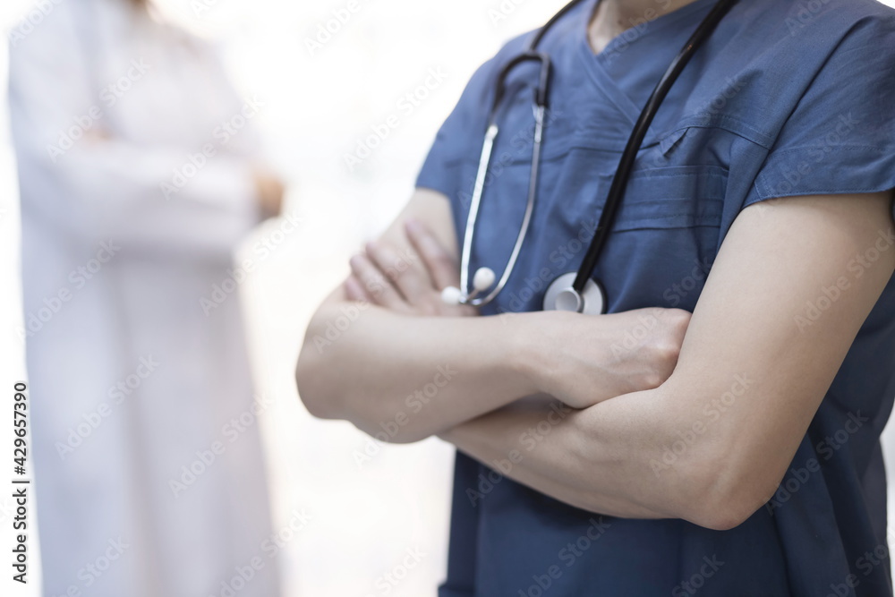 Doctors standing with arms folded at hospital Doctors standing with arms folded at hospital