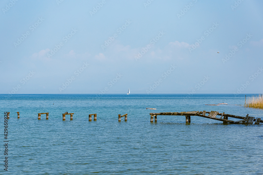 wooden pier destroyed on lake garda