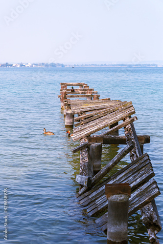 wooden pier on the lake, wooden pier destroyed on lake garda