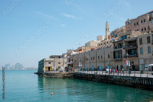 Old town and port of Jaffa and modern skyline of Tel Aviv city in blur background. © DVY714