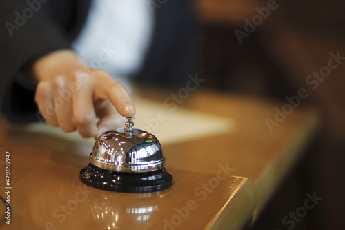 Hand of businesswoman using hotel bell