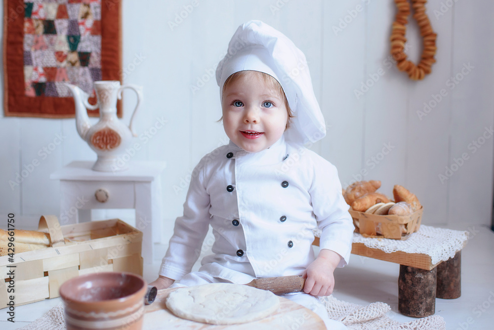 portrait of a little girl in baker clothes. choice of future profession portrait of a little girl in baker clothes. choice of future profession
