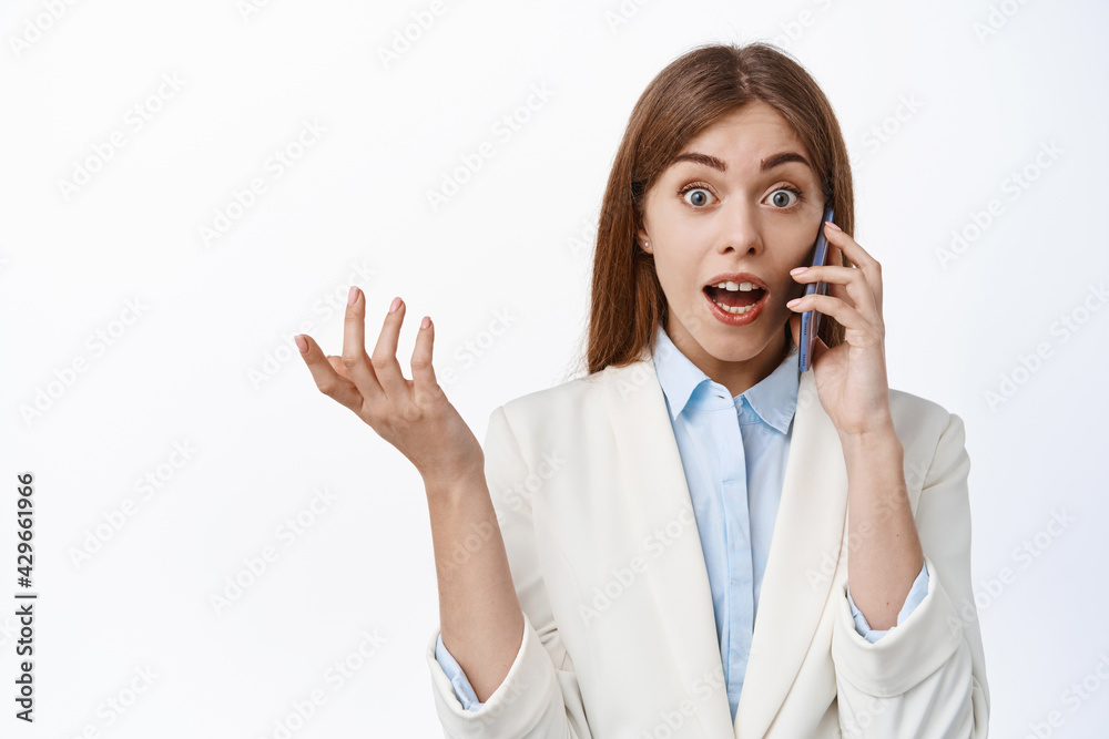 Surprised office woman ceo answer phone call, look amazed with disbelief, gasping astonished, white background Surprised office woman ceo answer phone call, look amazed with disbelief, gasping astonished, white background