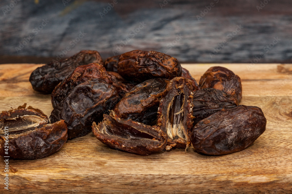 dried dates on a wooden table dried dates on a wooden table