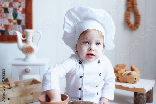 portrait of a little girl in baker clothes. choice of future profession