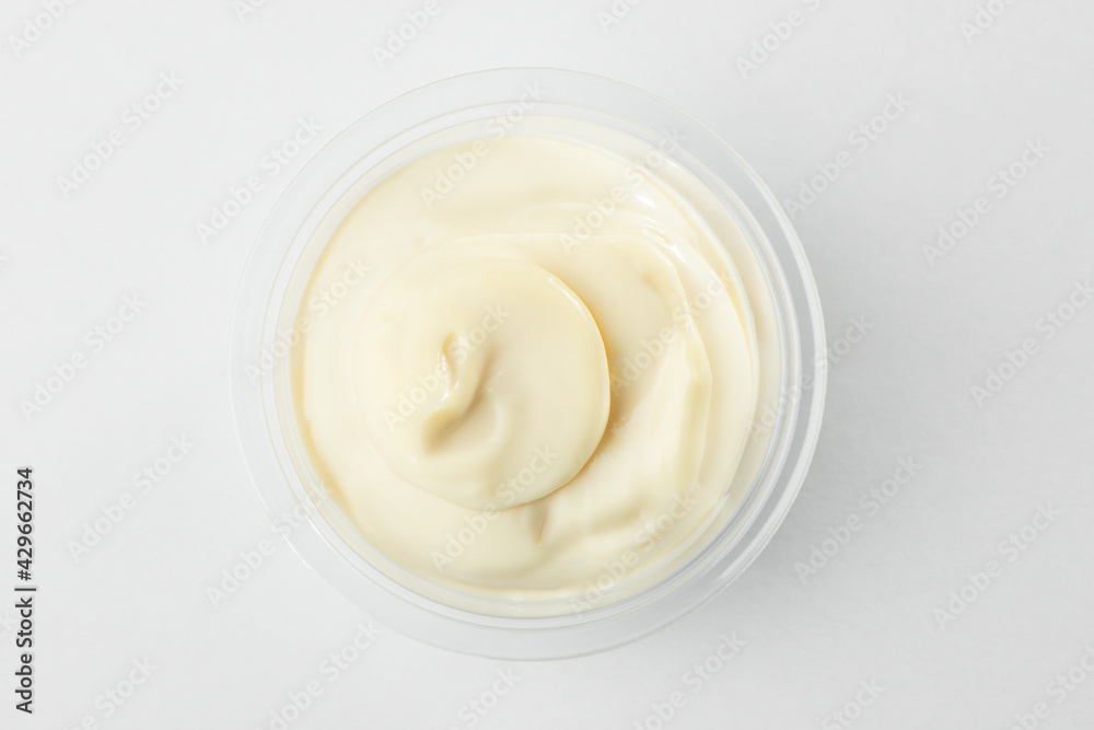 Top view on a cup of mayonnaise on white background Top view on a cup of mayonnaise on white background