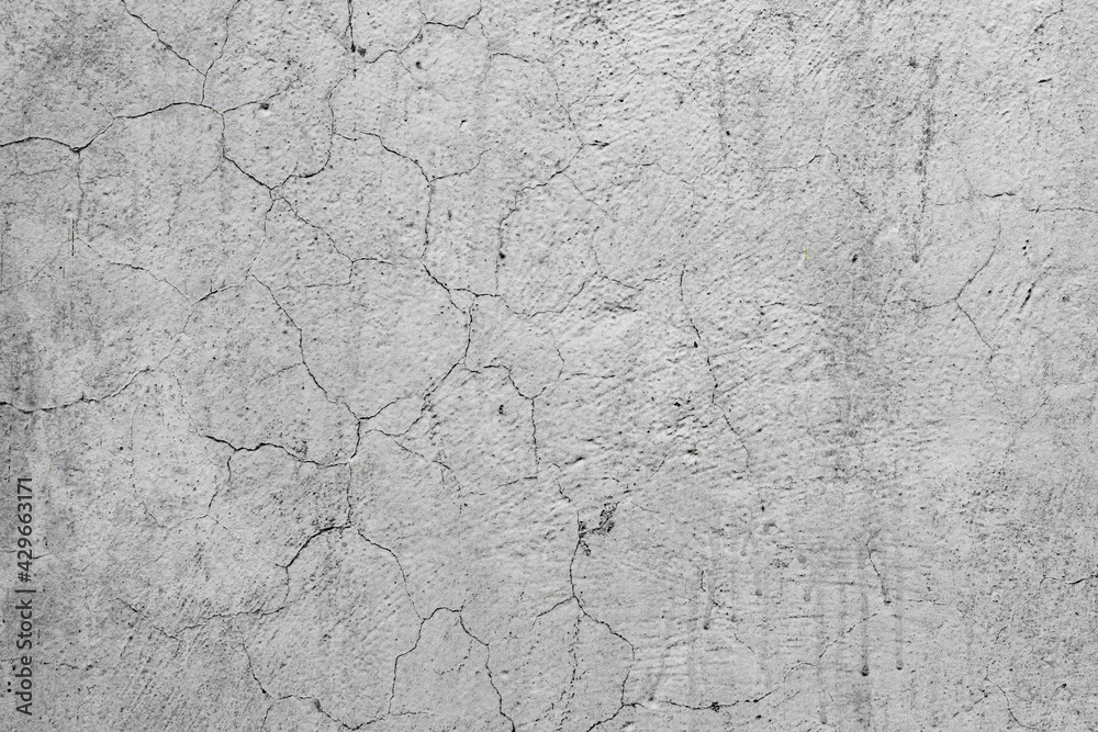 Texture of a concrete wall with cracks and scratches which can be used as a background