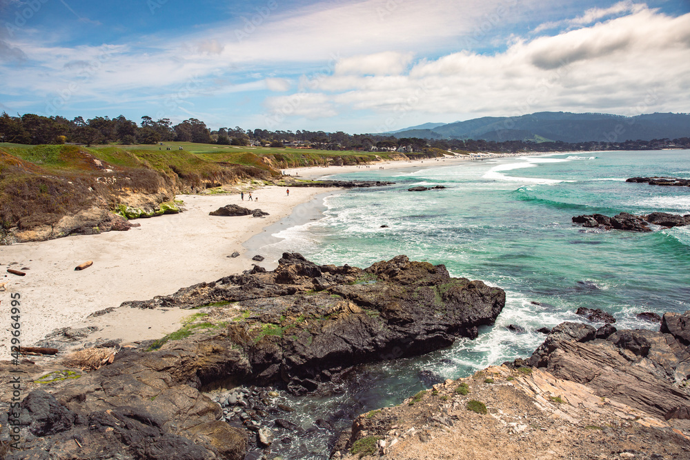 The Pacific Ocean coast in the city of Monterey in California. United States of America. Beautiful beach on a sunny day. Ocean landscape.