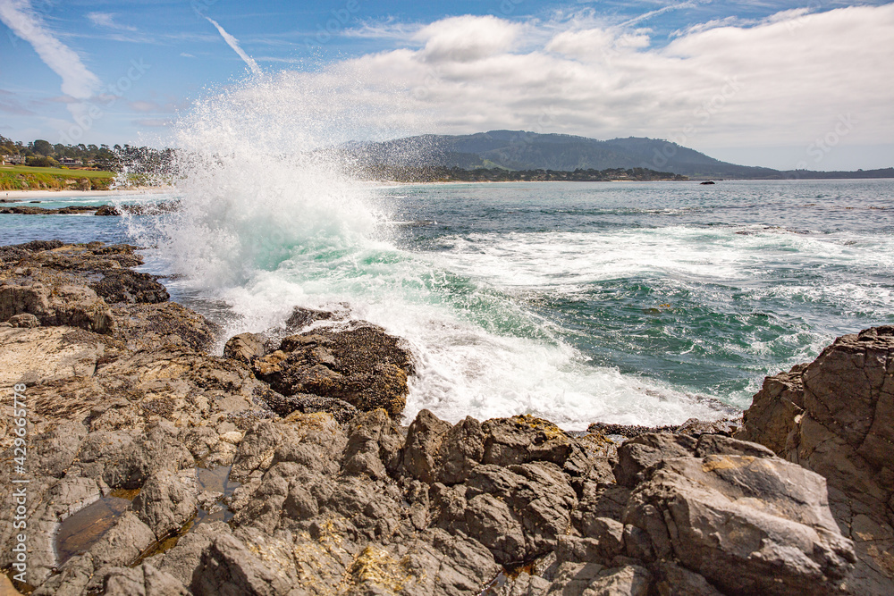 The Pacific Ocean coast in the city of Monterey in California. United States of America. Beautiful beach on a sunny day. Ocean landscape.
