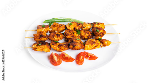 Chicken skewers with vegetables on white plate isolated on a white background. Souvlaki isolated.