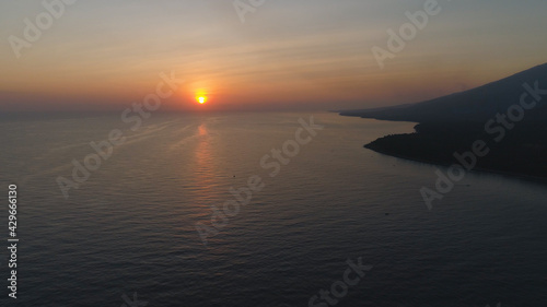 Fototapeta Naklejka Na Ścianę i Meble -  aerial view sunrise over ocean. seascape colorful sunrise over sea at tropical resort