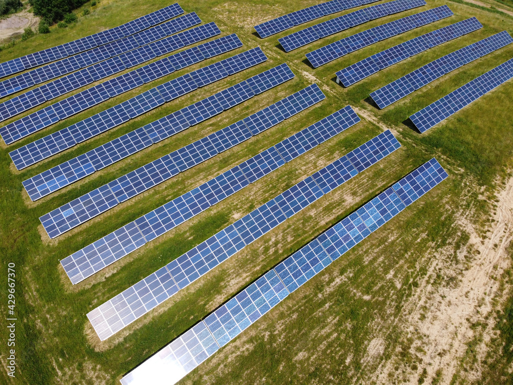 Solar Panels on green field in summer, aerial view, Poland