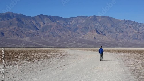 Man Walking At Badwater Basin, Death Valley National Park, California, USA. Static