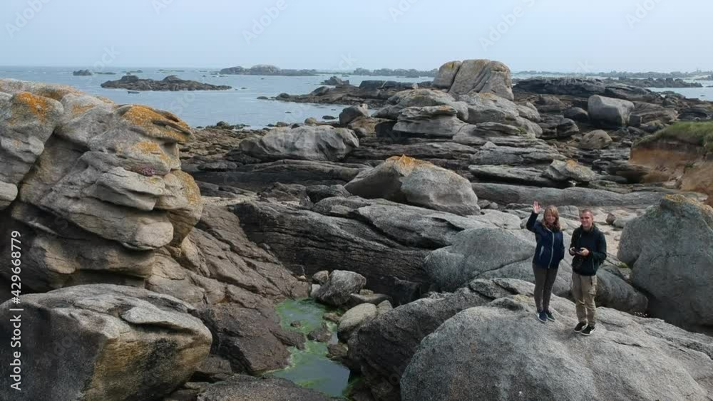 Rocky Coastline with Couple on Rock Rocky Coastline with Couple on Rock
