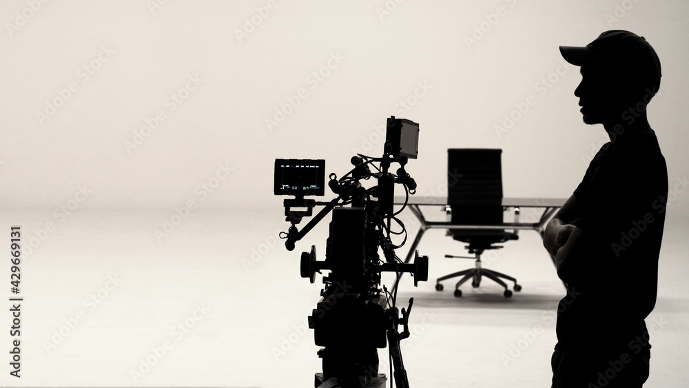 Silhouette of Behind the scenes or making of film. People working for shooting video production. White background studio with film crew team setup for filming.