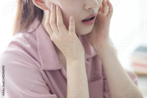 Woman suffering from toothache, tooth decay or sensitivity