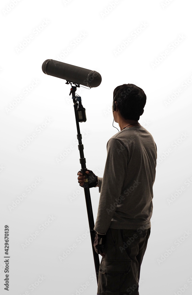 Boom Microphone hold up high by film crew. Boom man grabing a Big Boom  microphone in studio while recording online movie. Film Production concept.  Stock Photo | Adobe Stock