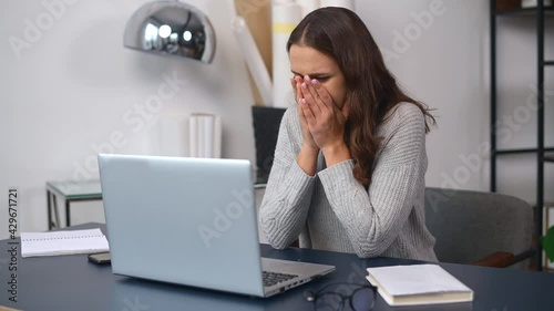Worried business woman in casual wear made a mistake in the work, sent the wrong email, upset female employee using laptop indoor, has trouble with project, holding head frustrated
