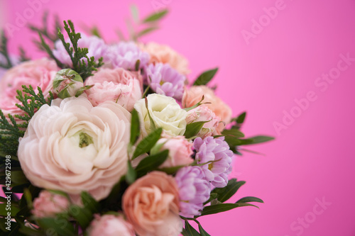 Beautiful bouquet of mixed different flowers on pink background, greeting, gift