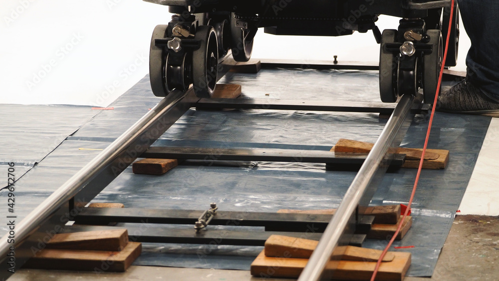 Dolly. Film production Dolly track. Production crew team setting dolly