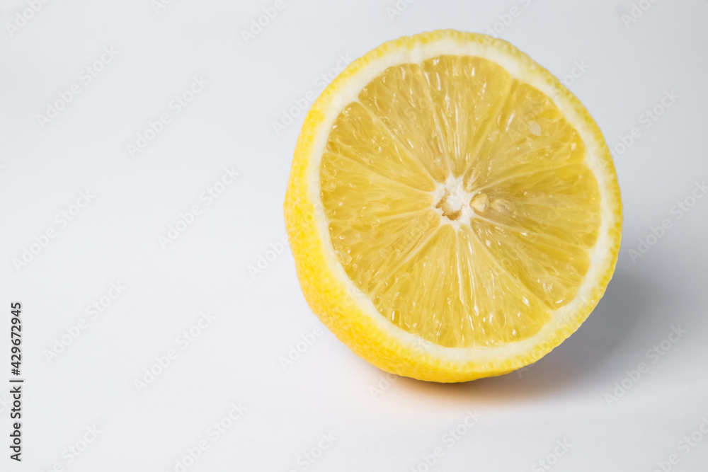 Lemon in cut on a white background. fresh and juicy lemon, cut in half. background Lemon in cut on a white background. fresh and juicy lemon, cut in half. background