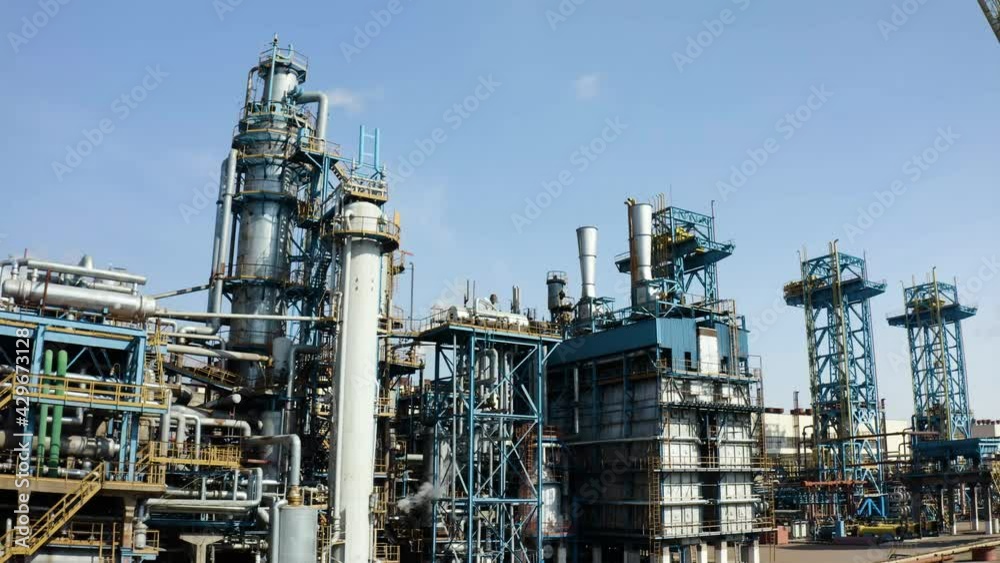 Aerial view of large oil refinery facilities. Plant factory of petrochemical industry and chemical manufacturing. Fuel and power resources. Shot from drone. Industrial factory aerial