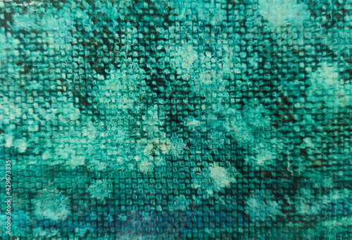 Spots and blots of green paint on the canvas. Abstract art background. 
