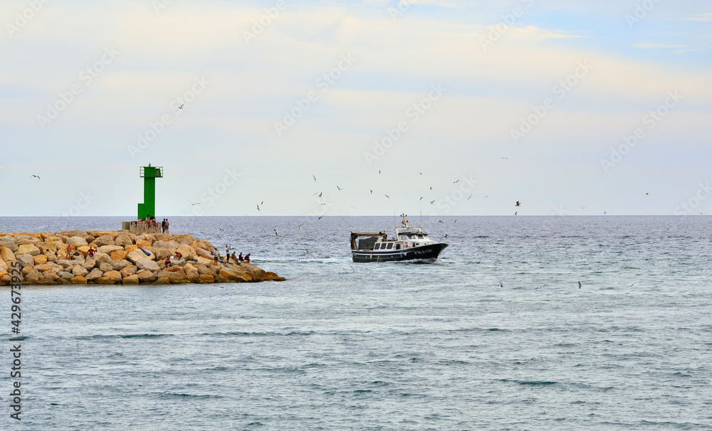 Fishing Boat Returns to the Harbor of Cambrils Catalonia Spain