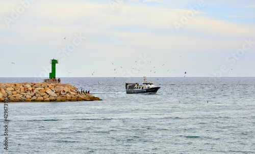 Fishing Boat Returns to the Harbor of Cambrils Catalonia Spain