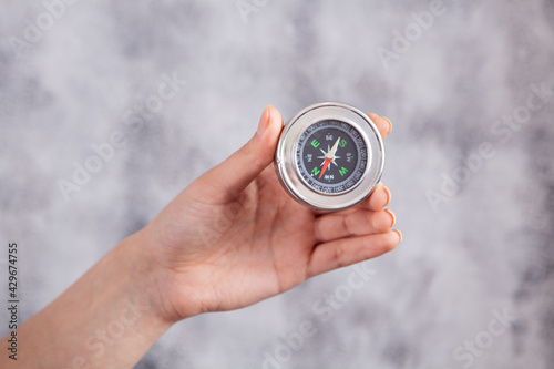 girl holding a compass in her hand