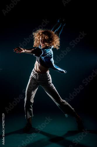 Modern style dancer isolated on dark background