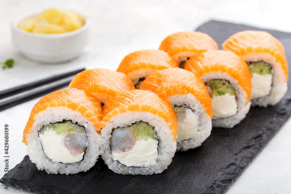 Sushi roll set with salmon, cucumber, cream cheese. Sushi menu. Japanese food. Sushi roll set with salmon, cucumber, cream cheese. Sushi menu. Japanese food.