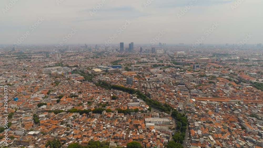 Fototapeta premium Aerial cityscape modern city Surabaya with skyscrapers, buildings and houses. urban environment in asia city skyline with skyscrapers and business centers java, indonesia
