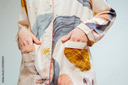 Beautiful booty of a young woman in fashionable beige pajamas
