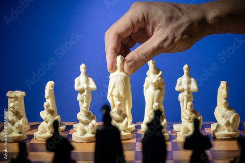 business chess strategy concept. person holding chess figure to make choice. creative leadership conceptual