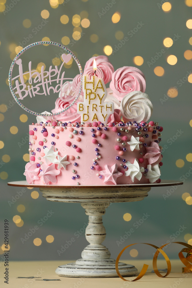 Beautiful birthday cake with festive decor and candle on white table - obrazy, fototapety, plakaty 