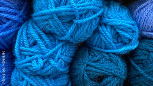 Blue and dark blue range of wool yarn. Multicolored skeins of wool close-up