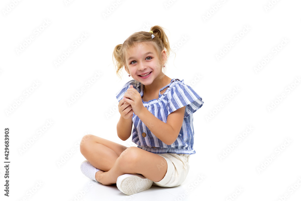 The little girl holds a chess piece in her hand. The little girl holds a chess piece in her hand.