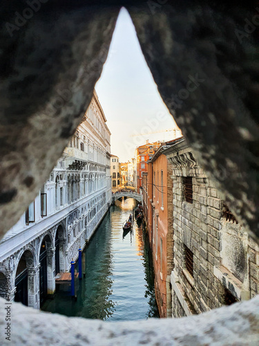 View from the bridge of sighs towards a peaceful canal in Venice, Italy.