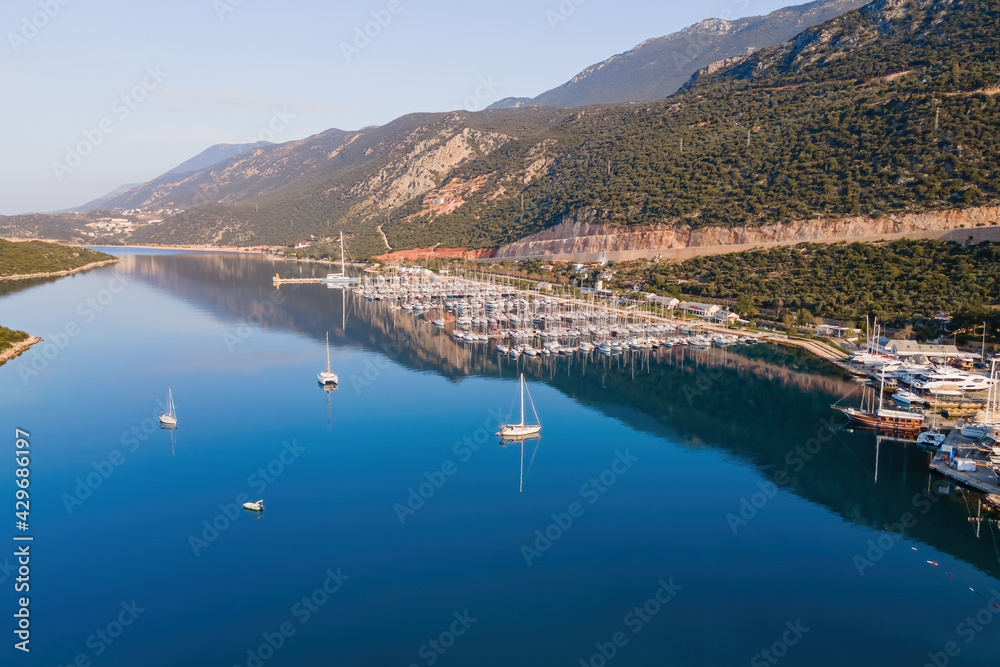 Yacht club with yachts docked in marine bay in Turkey. Aerial view of sailboats in lagoon.